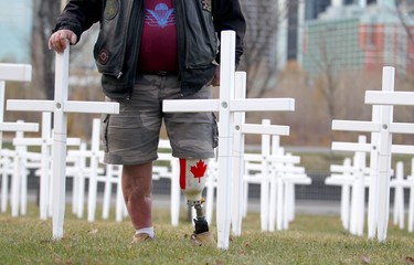 Paul Beaugrand, from 1 PPCLI and 2 PPCLI pauses during the set-up at the Field of Crosses Memorial Project in Calgary, Alta on Saturday October 22, 2016 near Memorial Dr and Centre St NW. Starting November 1st to November 11th, over 3,200 crosses are being displayed on a 5 acre city park in military cemetery formation to memorialize southern Alberta soldiers who were killed in action.  Each cross is inscribed with the name, age at death, rank, regiment and date of death of a soldier who lost his or her life in a foreign land, fighting for the freedoms we all enjoy today. Jim Wells/Postmedia