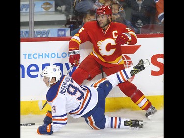 Flames Mark Giordano collides with Oilers Ryan Nugent-Hopkins during NHL action between the Edmonton Oilers and the Calgary Flames in Calgary, Alta. on Friday October 14, 2016. Jim Wells/Postmedia