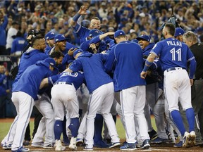 The Toronto Blue Jays'  Edwin Encarnacion hits a 3 run homer to give the Jays the win in the Wild Card Game at the Rogers Centre in Toronto, Ont. on Wednesday October 5, 2016. Stan Behal/Toronto Sun/Postmedia Network