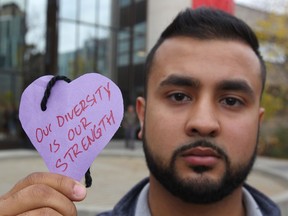 Umair Tazeem, president of the U of C Muslim Students' Association, holds up a message after the discovery of dozens of anti-Muslim posters on campus.