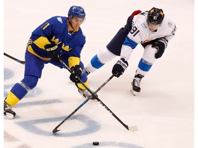 Mikael Backlund, left, of Team Sweden tries to get around Aleksander Barkov of Team Finland in the third period  during the World Cup of Hockey at the Air Canada Center on September 20, 2016 in Toronto, Canada. Sweden won the game 2-0.