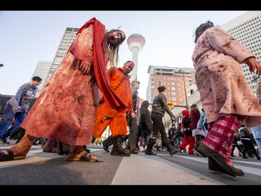 The undead trudge through the Zombie Walk in downtown Calgary, Alta., on Saturday, Oct. 15, 2016. The Zombie Walk is an annual event held mostly for fun but also to raise money and cash for the Calgary Food Bank. Lyle Aspinall/Postmedia Network