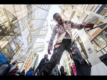 The undead trudge through the Zombie Walk in downtown Calgary, Alta., on Saturday, Oct. 15, 2016. The Zombie Walk is an annual event held mostly for fun but also to raise money and cash for the Calgary Food Bank. Lyle Aspinall/Postmedia Network