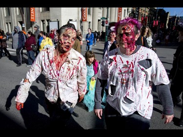 Connie Valin (L) and Cynthia Tessier join the Zombie Walk in downtown Calgary, Alta., on Saturday, Oct. 15, 2016. The Zombie Walk is an annual event held mostly for fun but also to raise money and cash for the Calgary Food Bank. Lyle Aspinall/Postmedia Network