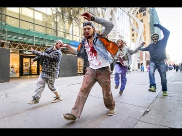 The undead dance through the Zombie Walk in downtown Calgary, Alta., on Saturday, Oct. 15, 2016. The Zombie Walk is an annual event held mostly for fun but also to raise money and cash for the Calgary Food Bank. Lyle Aspinall/Postmedia Network