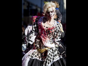 Jo Merritt goes through the Zombie Walk in downtown Calgary, Alta., on Saturday, Oct. 15, 2016. The Zombie Walk is an annual event held mostly for fun but also to raise money and cash for the Calgary Food Bank. Lyle Aspinall/Postmedia Network