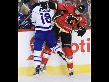 The Calgary Flames Troy Brouwer and the Toronto Maple Leafs' Mitchel Marner collide during the first period of NHL action at the Scotiabank Saddledome in Calgary on Wednesday November 30, 2016.