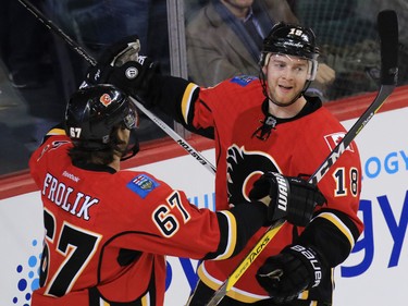 The Calgary Flames' Matt Stajan, right, celebrates scoring on the Toronto Maple Leafs' Jhonas Enroth in the first period of NHL action at the Scotiabank Saddledome in Calgary on Wednesday November 30, 2016.