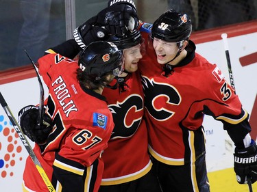 The Calgary Flames' Matt Stajan, centre, celebrates scoring with Michael Frolik, left and Alex Chiasson in the first period of NHL action at the Scotiabank Saddledome in Calgary on Wednesday November 30, 2016.