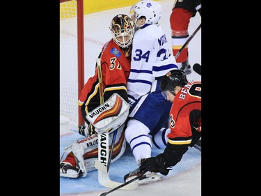 The Calgary Flames goaltender Chad Johnson collides with Toronto Maple Leafs forward Austin Matthews during the second period of NHL action at the Scotiabank Saddledome in Calgary on Wednesday November 30, 2016.