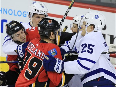 The Toronto Maple Leafs and Calgary Flames wrestle in from of the Leafs net during the second period of NHL action at the Scotiabank Saddledome in Calgary on Wednesday November 30, 2016.