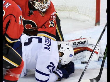 The Toronto Maple Leafs James van Riemsdyk goes down as Calgary Flames goaltender Chad Johnson stops the puck during the second period of NHL action at the Scotiabank Saddledome in Calgary on Wednesday November 30, 2016.