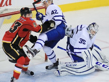 Toronto Maple Leafs goaltender Jhonas Enroth deals with the Calgary Flames Sam Bennett and teammate Tyler Bozak during the third period of NHL action at the Scotiabank Saddledome in Calgary on Wednesday November 30, 2016. 
GAVIN YOUNG/POSTMEDIA