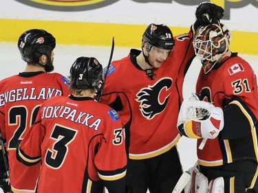 The Calgary Flames congratulate goaltender Chad Johnson on his 3-0 shut out against the Toronto Maple Leafs at the Scotiabank Saddledome in Calgary on Wednesday November 30, 2016. 
GAVIN YOUNG/POSTMEDIA