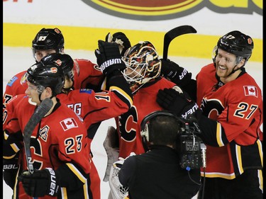 The Calgary Flames congratulate goaltender Chad Johnson on his 3-0 shut out against the Toronto Maple Leafs at the Scotiabank Saddledome in Calgary on Wednesday November 30, 2016. 
GAVIN YOUNG/POSTMEDIA