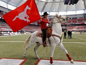 Karen Drake rides Quick Six (B.C.'s version) at B.C. Place before the start of the 102nd Canadian Football League Grey Cup championship game between the Calgary Stampeders and the Hamilton Tiger-Cats in Vancouver on Nov. 30, 214. Al Charest/Calgary Sun/QMI Agency