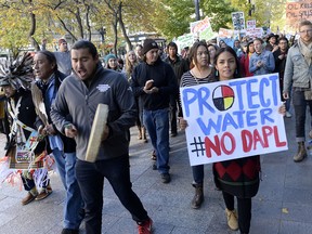 Protesters march in Salt Lake City in support of the Standing Rock Sioux against the Dakota Access Pipeline Monday, Oct. 31, 2016. The diverse group of over 100 held a rally at the Gallivan Center, then marched half a block to the Wells Fargo Center building. Wells Fargo is one of several major banks financing the pipeline. (Al Hartmann/The Salt Lake Tribune via AP) ORG XMIT: UTSAC301