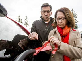Brenda and Dan Lavallee, whose daughter Jillian Lavallee was killed by a drunk driver last year, tie a MADD ribbon onto their vehicle at the Whitehorn Mult-Services Centre in Calgary, Alta., on Wednesday, Nov. 2, 2016. They were helping MADD Calgary launch its 29th annual holiday campaign to eliminate impaired driving. Lyle Aspinall/Postmedia Network