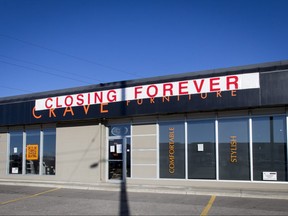 Going-out-of-business signs hang at Crave Furniture on 42 Ave SE in Calgary, Alta., on Sunday, Nov. 13, 2016. Lyle Aspinall/Postmedia Network