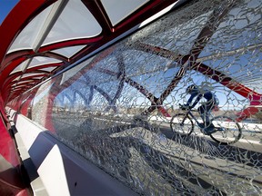 A smashed pane of glass mars the Peace Bridge over the Bow River.