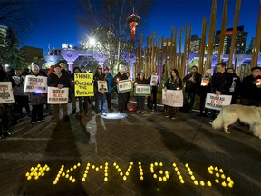 A crowd gathers in protest against Kinder Morgan at Olympic Plaza in downtown Calgary, Alta., on Monday, Nov. 21, 2016. More than 50 people were part of a protest against Kinder Morgan's proposal to expand and triple the capacity of its existing Trans Mountain pipeline from Strathcona County to the B.C. coast. Lyle Aspinall/Postmedia Network