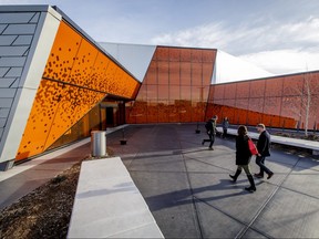 People walk into and out of the the new Great Plains Recreation Facility in southeast Calgary, Alta., during its grand opening celebration on Saturday, Nov. 26, 2016. The 80,000-sq-ft facility houses two arenas and holds about 600 spectators. Lyle Aspinall/Postmedia Network