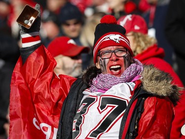A Calgary Stampeders' fan cheers during first quarter CFL western final action against the B.C. Lions, in Calgary on Sunday, Nov. 20, 2016.