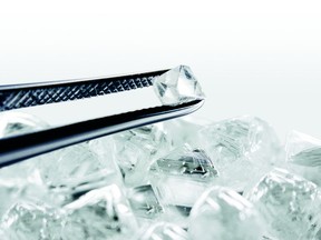 A pair of tweezers holds a Forevermark diamond. For story on diamonds by Shelley Boettcher, for Herald LIfe.