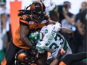 B.C. Lions' Solomon Elimimian, above, and Bryant Turner Jr., below, tackle Saskatchewan Roughriders' Joe McKnight during CFL action in Vancouver on Nov. 5, 2016.