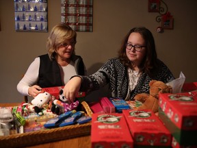 Anna Pheby, 14, and mentor Cheri Miles work on Christmas boxes at Cheri's house on Nov. 16, 2016.  After Anna's father died,  her mom thought she needed someone else in her life and they found a lifelong friend  through Big Brothers Big Sisters.