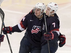 Auston Matthews, left, and Matthew Tkachuk of the U.S celebrate a goal during the 2016 IIHF World Junior Ice Hockey Championship bronze medal game between Sweden and the USA in Helsinki, Finland, Tuesday, Jan. 5, 2016.