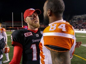 BC Lions Emmanuel Arceneaux talks with Calgary Stampeders Bo Levi Mitchell  in Western Final CFL action at McMahon Stadium in Calgary, Alta.. on Sunday November 20, 2016. The Stamps beat the Lions 42-15. Mike Drew/Postmedia