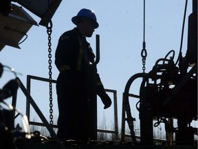 An oilfield worker toils on a rig near Drayton Valley.
