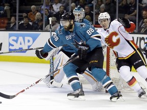 San Jose Sharks' Brent Burns (88) is pursued by Calgary Flames' Mikael Backlund during the second period of an NHL hockey game Monday, Feb. 9, 2015, in San Jose, Calif.