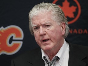 Brian Burke, the Calgary Flames' president of hockey operations, speaks with media at the Scotiabank Saddledome in 2014.