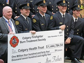 Burn victim Don Adamson, left, poses with firefighters representing the Calgary Firefighters Burn Treatment Society after the society donated $1.44 million to the Calgary Health Trust for burn treatment programs in Alberta. The presentation took place at the Foothills Hospital on Thursday, Nov. 17, 2016.