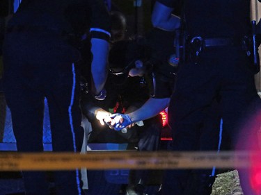 Paramedics check over a police officer at the scene of an officer involved shooting in Dover in Calgary on Thursday night November 3, 2016.
GAVIN YOUNG/POSTMEDIA