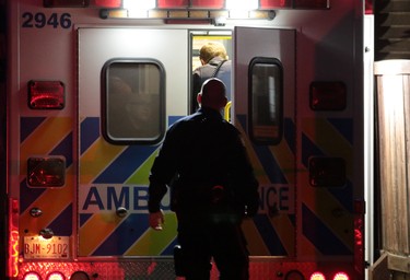 Police check on an officer being checked over in an ambulance after an involved shooting in Dover in Calgary on Thursday night November 3, 2016.