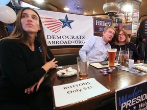 From left; Sibyl Kleiner, Dean Kasner and Margot Betz nervously watch the U.S. election results roll in at the Kilkenny Irish Pub in northwest Calgary on Tuesday November 8, 2016. The event was organized by Calgary chapter of Democrats Abroad.