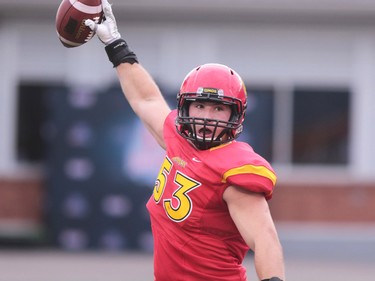 Calgary Dinos linebacker Jakub Jakoubek celebrates scoring a touchdown after recovering a UBC Thunderbirds fumble during the Hardy Cup at McMahon Stadium in Calgary on Saturday November 12, 2016.