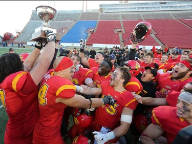 The Calgary Dinos football team celebrates winning the Hardy Cup action defeating the UBC Thunderbirds 46-43 at McMahon Stadium in Calgary on Saturday November 12, 2016.