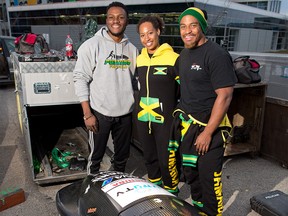 Jamaican Bobsled team members from left; Seldwyn Morgan, Jazmine Fenlator-Victorian and Surf Fenlator-Victorian prepare to package up a bobsled for transport to Whistler after training at Canada Olympic Park in Calgary on November 13, 2016. The team is looking to find some new wheels after their team van broke down. GAVIN YOUNG/POSTMEDIA