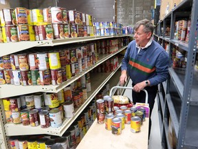 Volunteer Brian Hagerman assembles a food hamper from the now full shelves at the Veterans Food Bank on Wednesday November 16, 2016. The food bank has filled four warehouses with donations after a recent call for help.