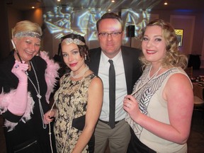 Cal 1126 Ronald 3 All smiles at the 1920's themed Taste of Home dinner in support of Ronald McDonald House Charities Southern Alberta are, from left, Ronald McDonald House director Lisa Barrett, Janelle Mayo, House CEO Jason Evanson and Dayna McCombs.   The event raised $100,000 for the House.