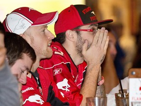 Calgary Stampeders fans Leo King, left and Levi Frehlich nervously watch during an Ottawa Redblacks offensive drive during the first half of the Grey Cup at the Home & Away bar in Calgary's beltline on Sunday November 27, 2016.  GAVIN YOUNG/POSTMEDIA