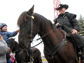 Bo Fornataro, 1, and his grandfather Russ Fornataro got a chance to meet Ranger the police horse during the Disaster Alley demonstration to kick off Emergency Preparedness Week at McMahon Stadium on May 4, 2014. Christina Ryan/Postmedia