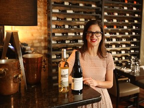 Blink Restaurant and Bar owner Leslie Echino, with bottles of the exclusive wine she's selling to raise money for Hospice Calgary.