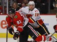 CHICAGO, IL - NOVEMBER 01: Marian Hossa #81 of the Chicago Blackhawks is knocked to the ice by Matt Stajan #18 of the Calgary Flames at the United Center on November 1, 2016 in Chicago, Illinois.