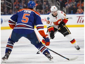 Mark Fayne of the Edmonton Oilers, left, skates against Linden Vey of the Calgary Flames on September 26, 2016 at Rogers Place in Edmonton, Alberta, Canada.