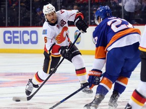 NEW YORK, NY - OCTOBER 26: Dennis Wideman #6 of the Calgary Flames takes the shot against the New York Islanders at the Barclays Center on October 26, 2015 in the Brooklyn borough of New York City.